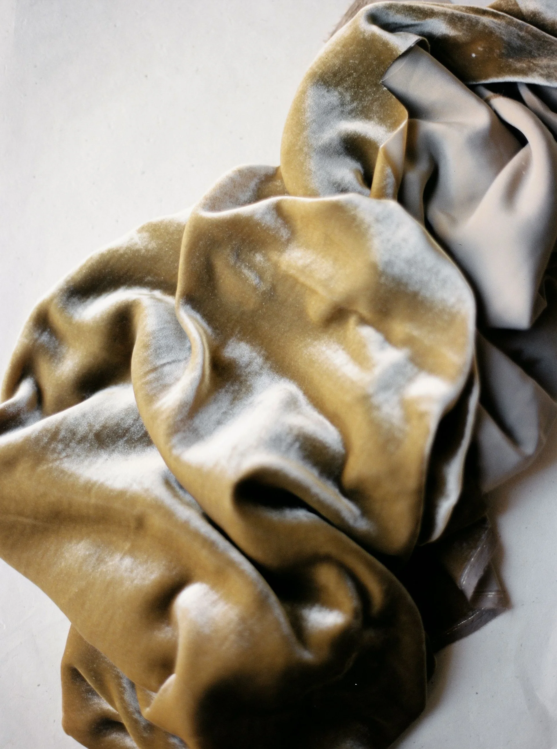 Close-up photograph of brown velvet folds and surface texture